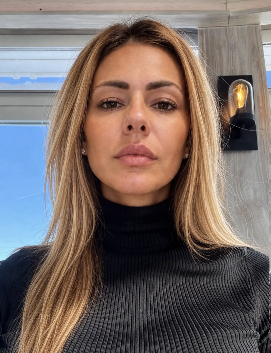 Close-up portrait, no makeup, black turtleneck